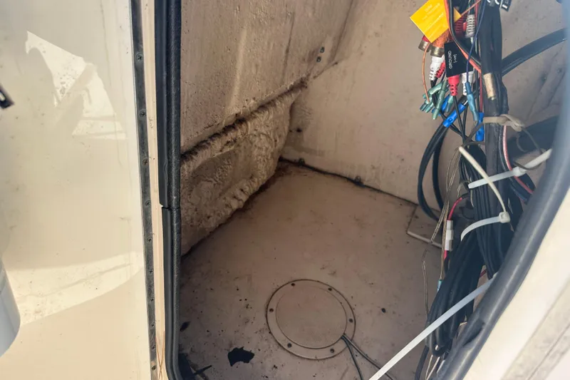 Slide: The Image of Interior view of a 2004 Grady-White Sportsman 180 boat compartment with wiring. - 20