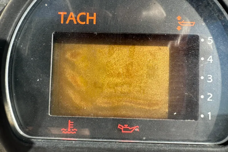 Slide: The Image of Tachometer display of a 2004 Grady-White Sportsman 180 boat, showing engine indicators. - 24