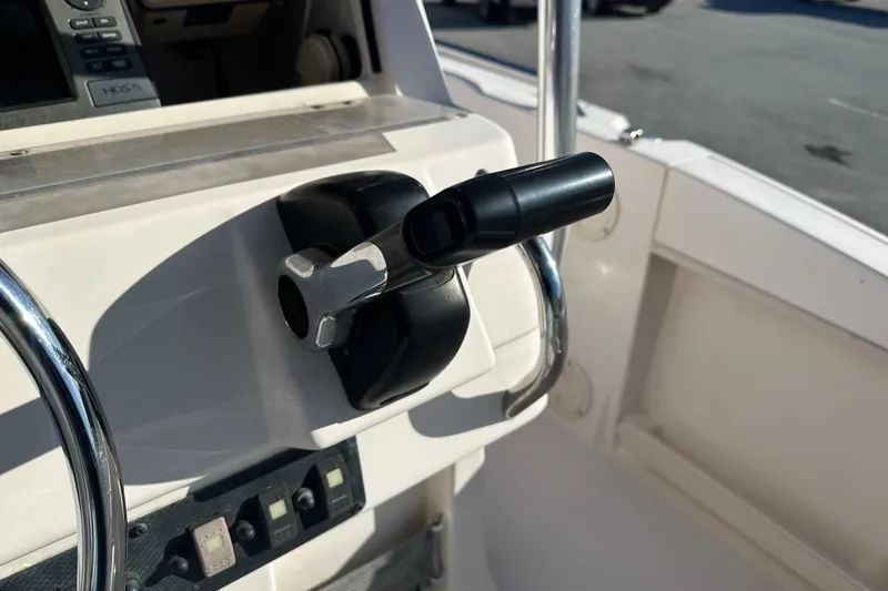 Slide: The Image of Close-up of 2004 Grady-White Sportsman 180 boat throttle control and dashboard. - 28