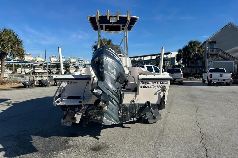 Slide: The Image of 2004 Grady-White Sportsman 180 boat with Yamaha engine, parked in a marina. - 3