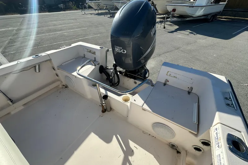 Slide: The Image of 2004 Grady-White Sportsman 180 boat with Yamaha 150 outboard motor in parking lot. - 30
