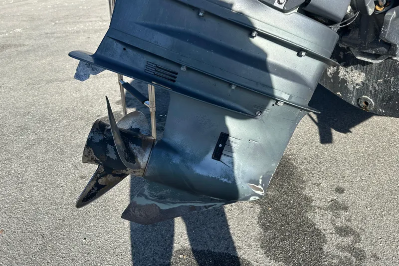 Slide: The Image of 2004 Grady-White Sportsman 180 boat motor with visible wear and propeller damage. - 5