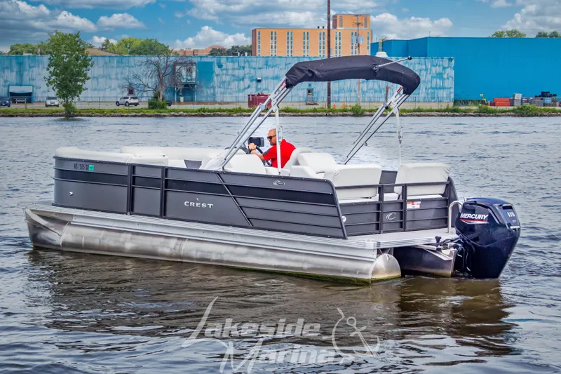 Slide: The Image of 2021 Crest Classic LX 220 SLRC pontoon boat on a calm river. - 10