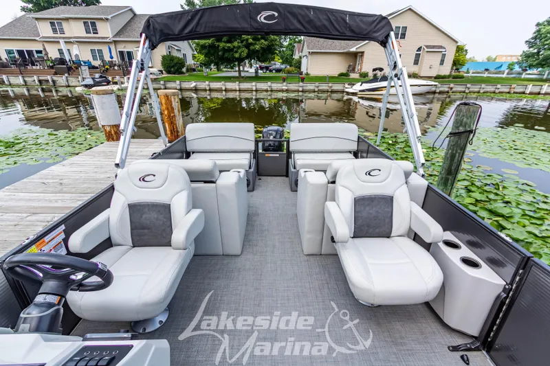 Slide: The Image of 2021 Crest Classic LX 220 SLRC pontoon boat interior at dockside. - 17