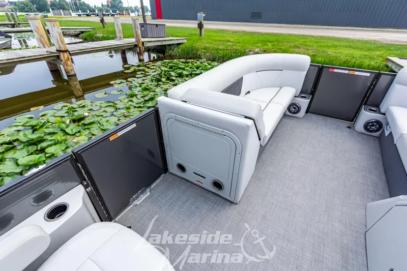 Slide: The Image of 2021 Crest Classic LX 220 SLRC pontoon boat interior with white seating and lake view. - 19