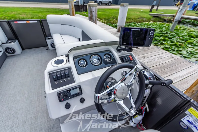 Slide: The Image of 2021 Crest Classic LX 220 SLRC boat dashboard with steering wheel and controls at Lakeside Marina. - 22