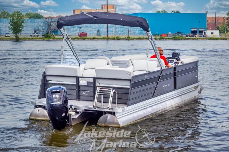 Slide: The Image of 2021 Crest Classic LX 220 SLRC pontoon boat cruising on a river. - 7
