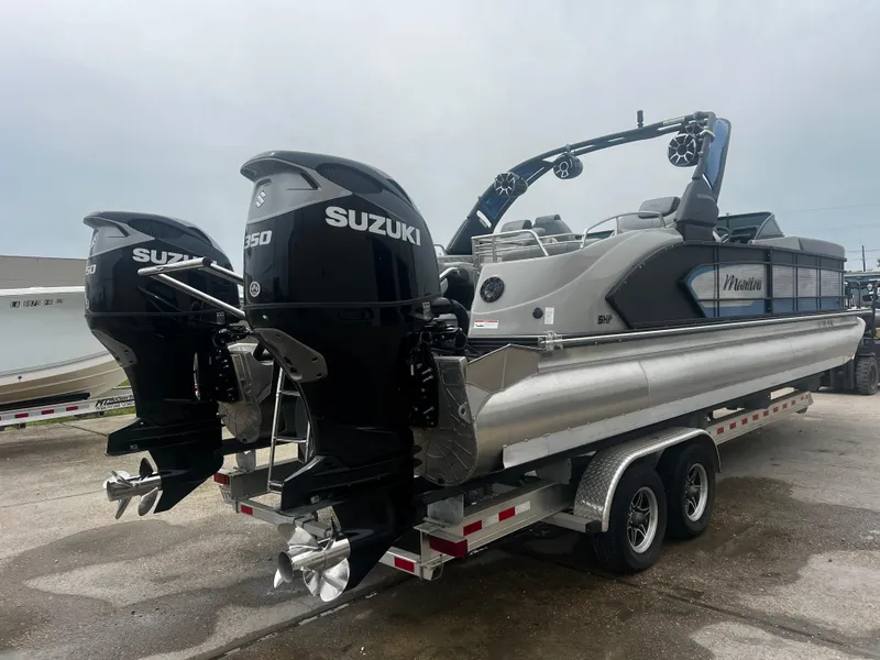 Slide: The Image of 2022 Manitou 27 pontoon boat with dual Suzuki 250 engines on a trailer. - 11