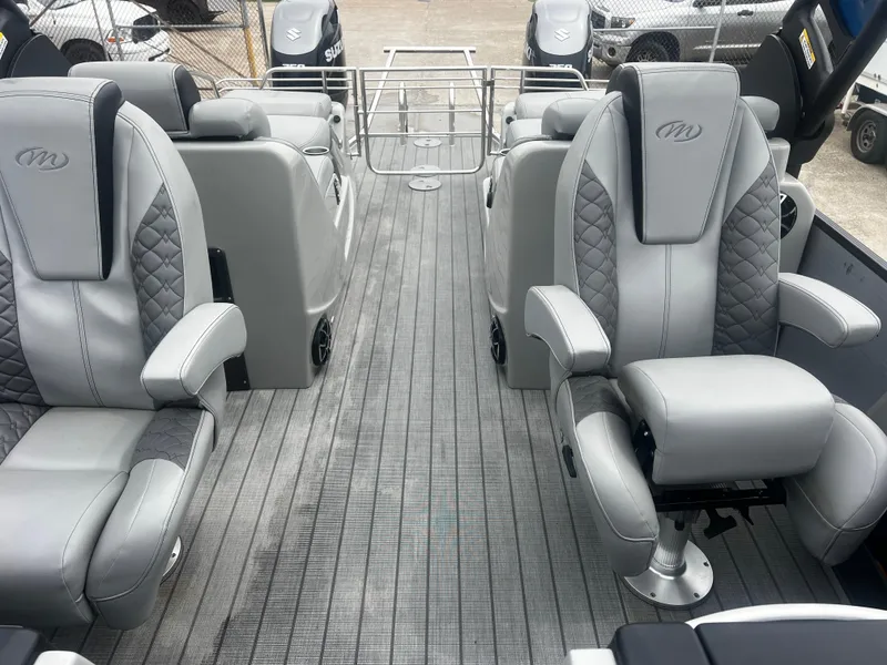 Slide: The Image of Luxurious 2022 Manitou 27 boat interior with plush gray seating and modern design. - 2