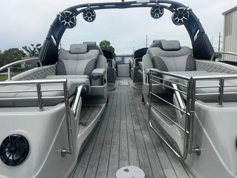 Slide: The Image of 2022 Manitou 27 boat interior with luxurious seating and modern design. - 9