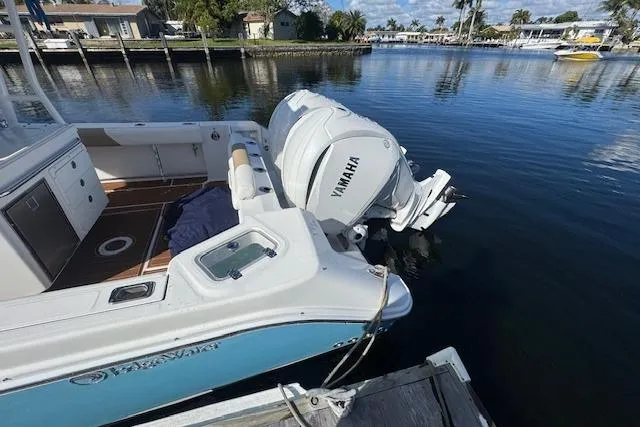 Slide: The Image of 2022 Edgewater 280CC boat docked, featuring Yamaha outboard engines, calm water background. - 10