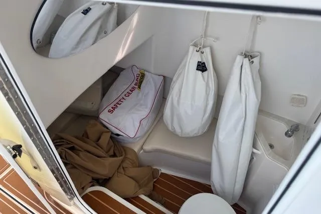 Slide: The Image of 2022 Edgewater 280CC interior with safety gear bag and storage area. - 11