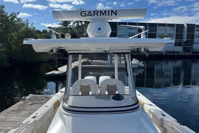 Slide: The Image of 2022 Edgewater 280CC boat docked, featuring Garmin radar, clear skies, and waterfront buildings. - 15