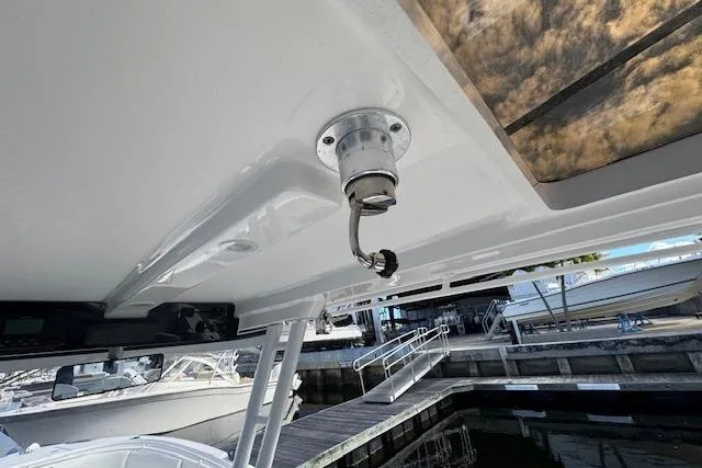 Slide: The Image of 2022 Edgewater 280CC boat detail showing a mounted light fixture at a marina. - 22