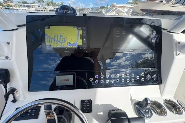 Slide: The Image of Edgewater 280CC 2022 boat dashboard with navigation screens and controls. - 25