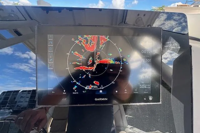 Slide: The Image of Garmin navigation display on 2022 Edgewater 280CC boat, showing radar and weather data. - 29