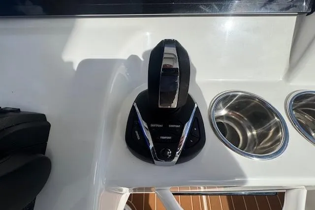 Slide: The Image of Throttle control and cup holders on 2022 Edgewater 280CC boat dashboard. - 30