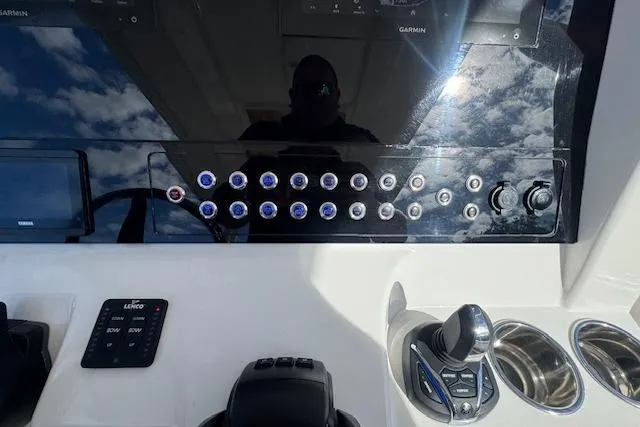 Slide: The Image of Control panel of 2022 Edgewater 280CC boat with buttons and joystick. - 32