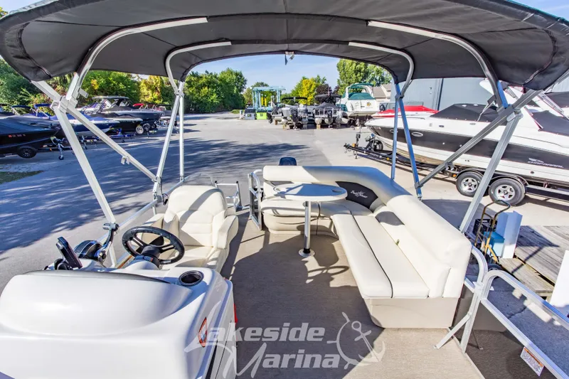 Slide: The Image of 2021 SunChaser Geneva Cruise 20 CRS pontoon boat with canopy at marina. - 14