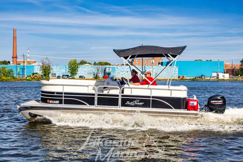 Slide: The Image of 2021 SunChaser Geneva Cruise 20 CRS pontoon boat cruising on a river with two passengers. - 2