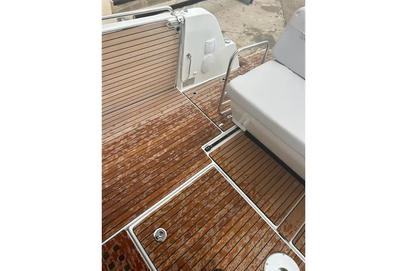 Slide: The Image of 2025 Beneteau Antares 11 Coupe boat ladder and outboard motor detail. - 10