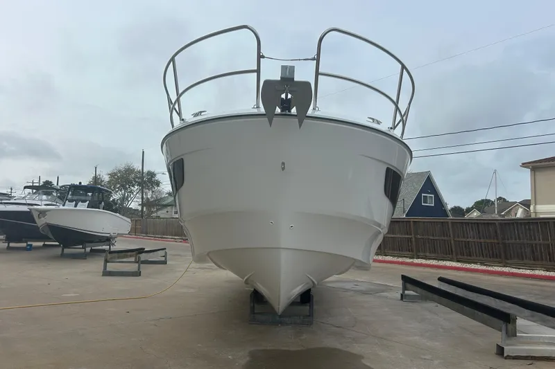 Slide: The Image of 2025 Beneteau Antares 11 Coupe deck with wet wooden flooring and metal railing. - 13