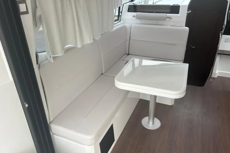 Slide: The Image of 2025 Beneteau Antares 11 Coupe deck with teak flooring and seating area. - 15