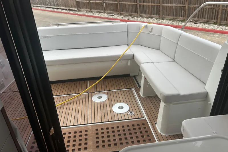 Slide: The Image of 2025 Beneteau Antares 11 Coupe boat on display in a marina setting. - 18