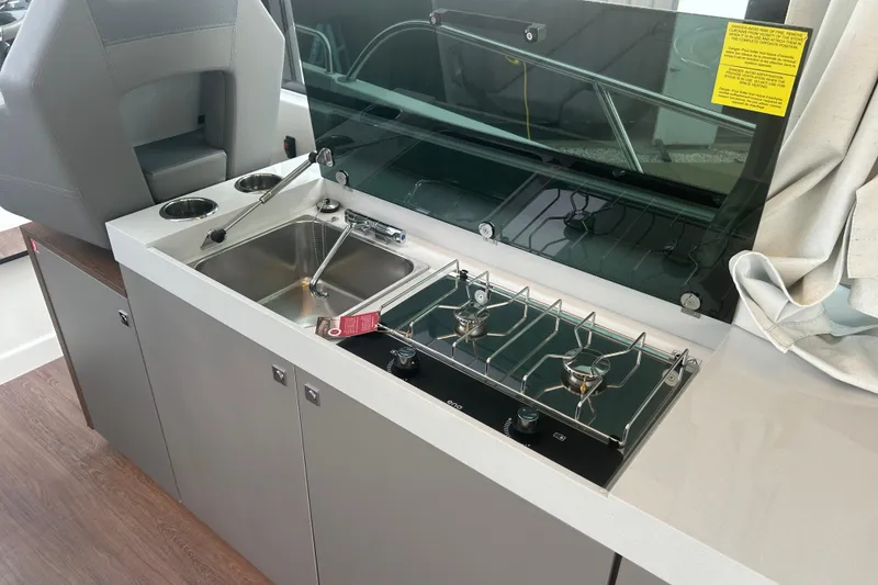 Slide: The Image of Interior of 2025 Beneteau Antares 11 Coupe with modern kitchen and helm station. - 19