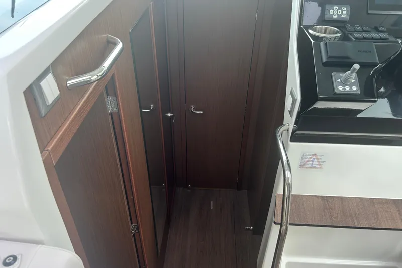 Slide: The Image of Interior of 2025 Beneteau Antares 11 Coupe with sleek white seating and table. - 22