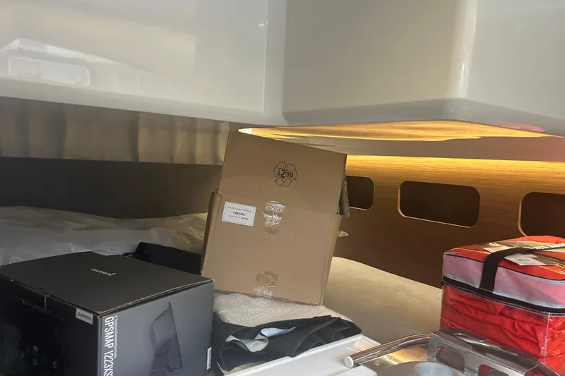 Slide: The Image of Interior of 2025 Beneteau Antares 11 Coupe, featuring cozy seating and wooden finishes. - 28