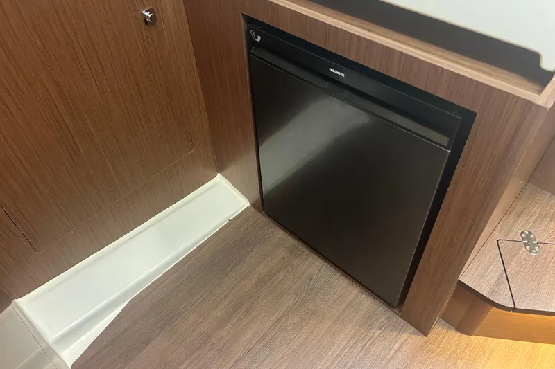 Slide: The Image of Bathroom interior of 2025 Beneteau Antares 11 Coupe, featuring modern fixtures and wood accents. - 35