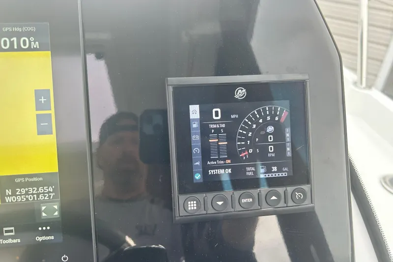 Slide: The Image of 2025 Beneteau Antares 11 Coupe interior with compact black refrigerator. - 40