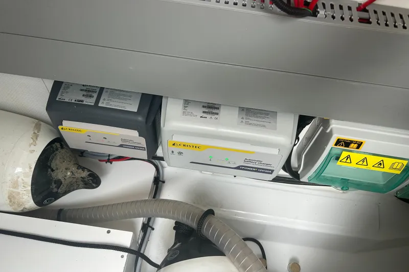 Slide: The Image of Battery chargers and electrical components in a 2025 Beneteau Antares 11 Coupe boat. - 47
