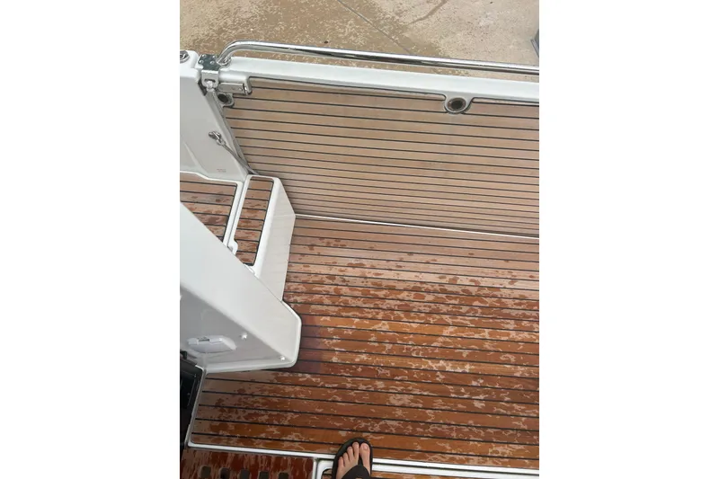 Slide: The Image of 2025 Beneteau Antares 11 Coupe with dual outboard engines at dockside. - 8