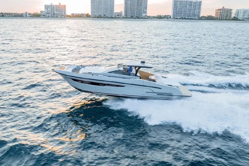 The Image of 2024 Rio Yachts Daytona 50 cruising on open water near city skyline. - 0