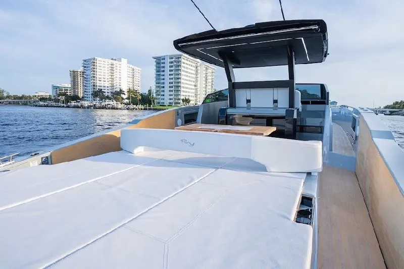 Slide: The Image of 2024 Rio Yachts Daytona 50 luxury yacht on water with cityscape background. - 16