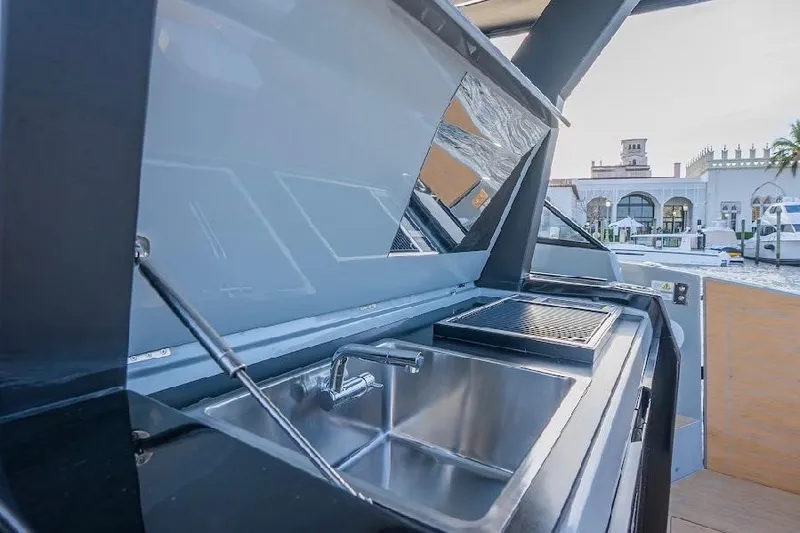 Slide: The Image of Outdoor kitchen on 2024 Rio Yachts Daytona 50, featuring a sink and grill. - 18