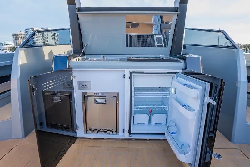 Slide: The Image of 2024 Rio Yachts Daytona 50 outdoor kitchen with fridge and storage compartments. - 19