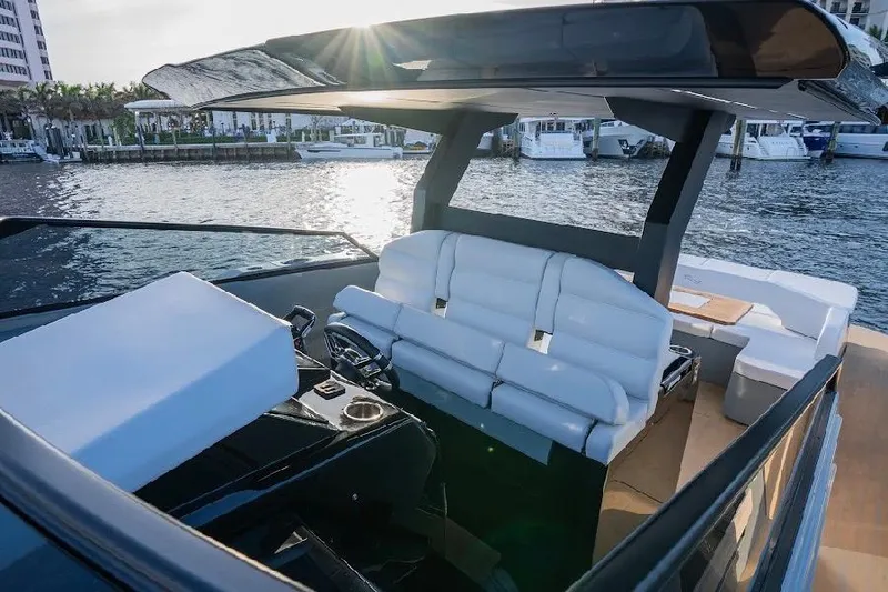 Slide: The Image of 2024 Rio Yachts Daytona 50 cockpit with luxurious seating and waterfront view. - 21