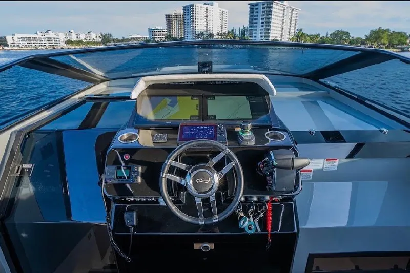 Slide: The Image of 2024 Rio Yachts Daytona 50 helm with modern navigation controls and ocean view. - 24