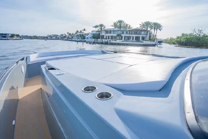 Slide: The Image of 2024 Rio Yachts Daytona 50 luxury yacht on serene waterfront with modern architecture. - 25