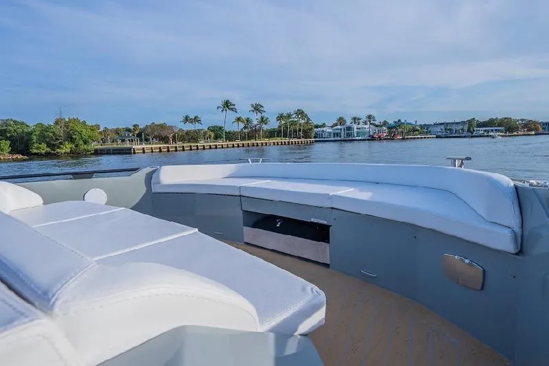 Slide: The Image of 2024 Rio Yachts Daytona 50 luxury deck with waterfront view and palm trees. - 27