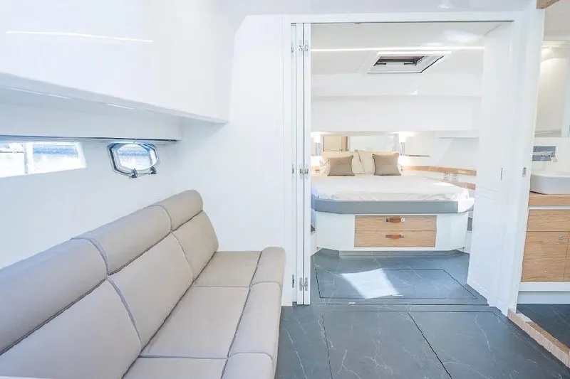 Slide: The Image of Luxurious interior of 2024 Rio Yachts Daytona 50 with modern seating and spacious bedroom. - 28