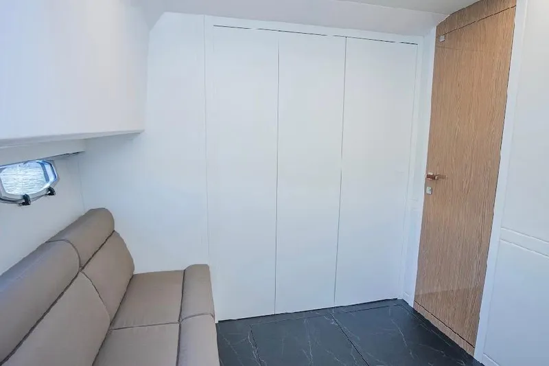 Slide: The Image of 2024 Rio Yachts Daytona 50 interior with beige seating and sleek modern design. - 29