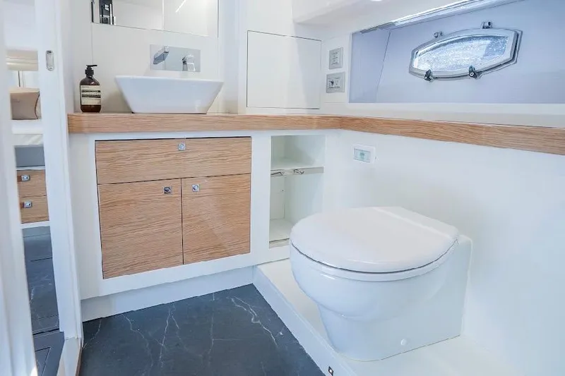 Slide: The Image of Luxurious bathroom in 2024 Rio Yachts Daytona 50 with modern fixtures and wood accents. - 30