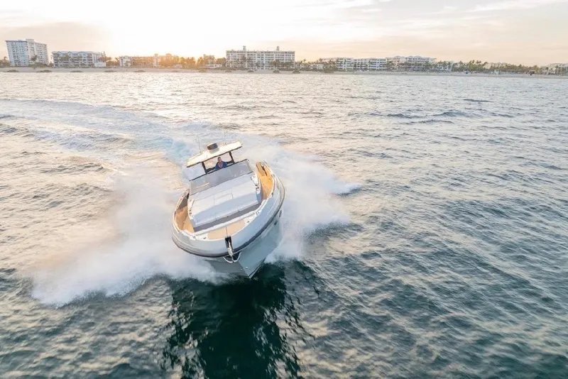 Slide: The Image of 2024 Rio Yachts Daytona 50 cruising on open water at sunset. - 4