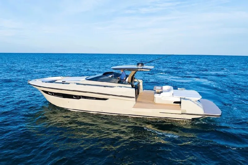 Slide: The Image of 2024 Rio Yachts Daytona 50 cruising on open sea under clear blue sky. - 8