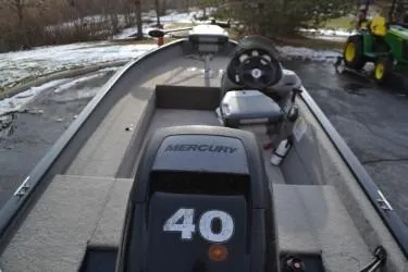 Slide: The Image of 2013 Tracker Super Guide V-16 SC boat with Mercury 40 engine, parked on snowy driveway. - 5