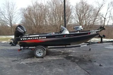 Slide: The Image of 2013 Tracker Super Guide V-16 SC fishing boat on trailer, parked outdoors. - 7